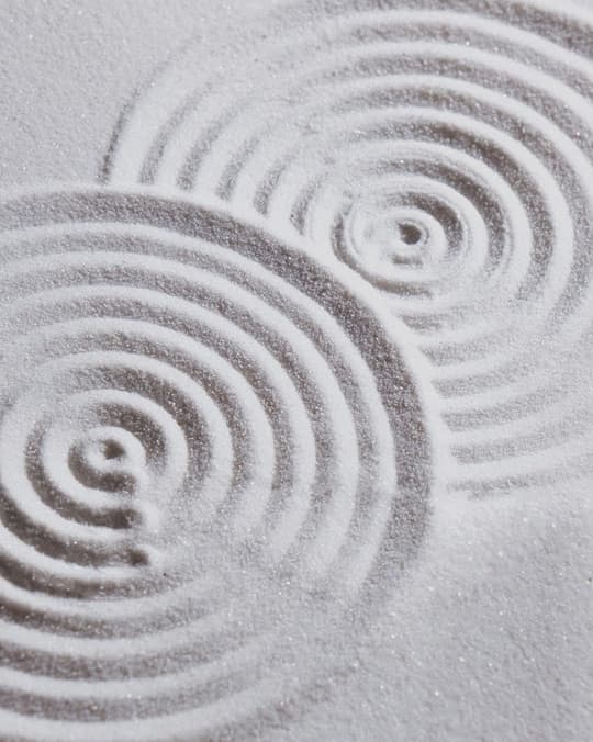 Concentric ripples raked into a zen sand garden