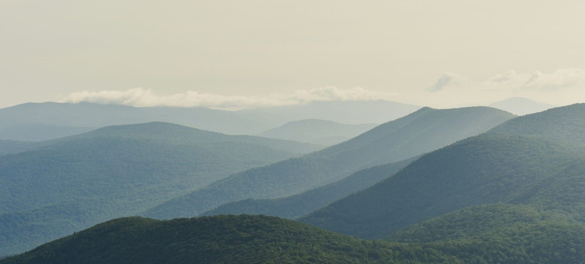 Layers of misty blue mountain ridges receding into the distance